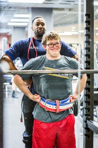 photo of child and man posing in gym